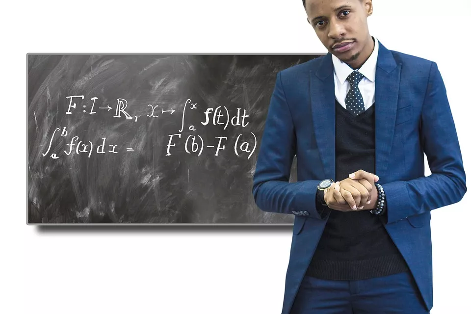 black professor in front of a chalkboard